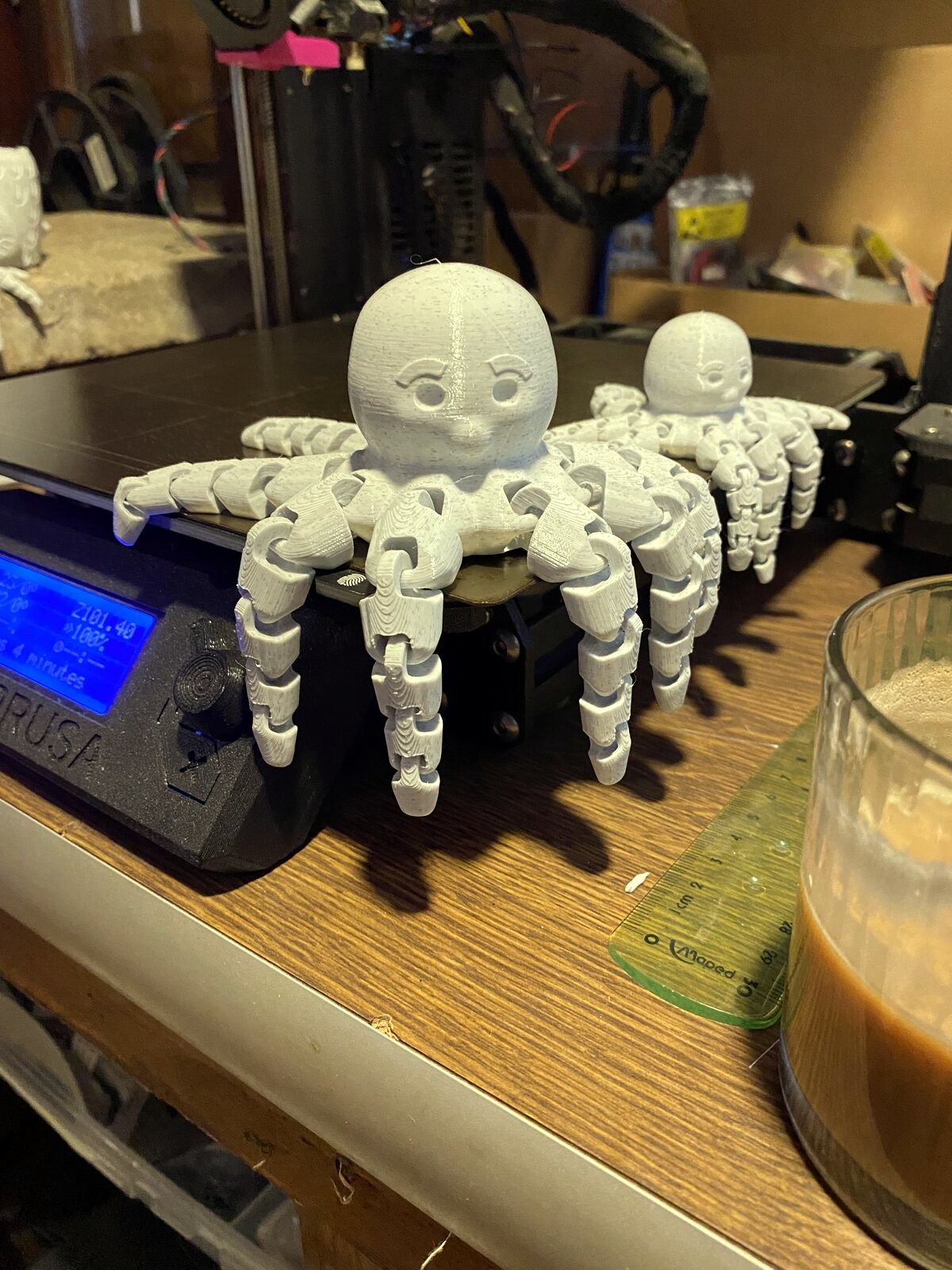 Jointed 3D printed toy robots standing on a shelf